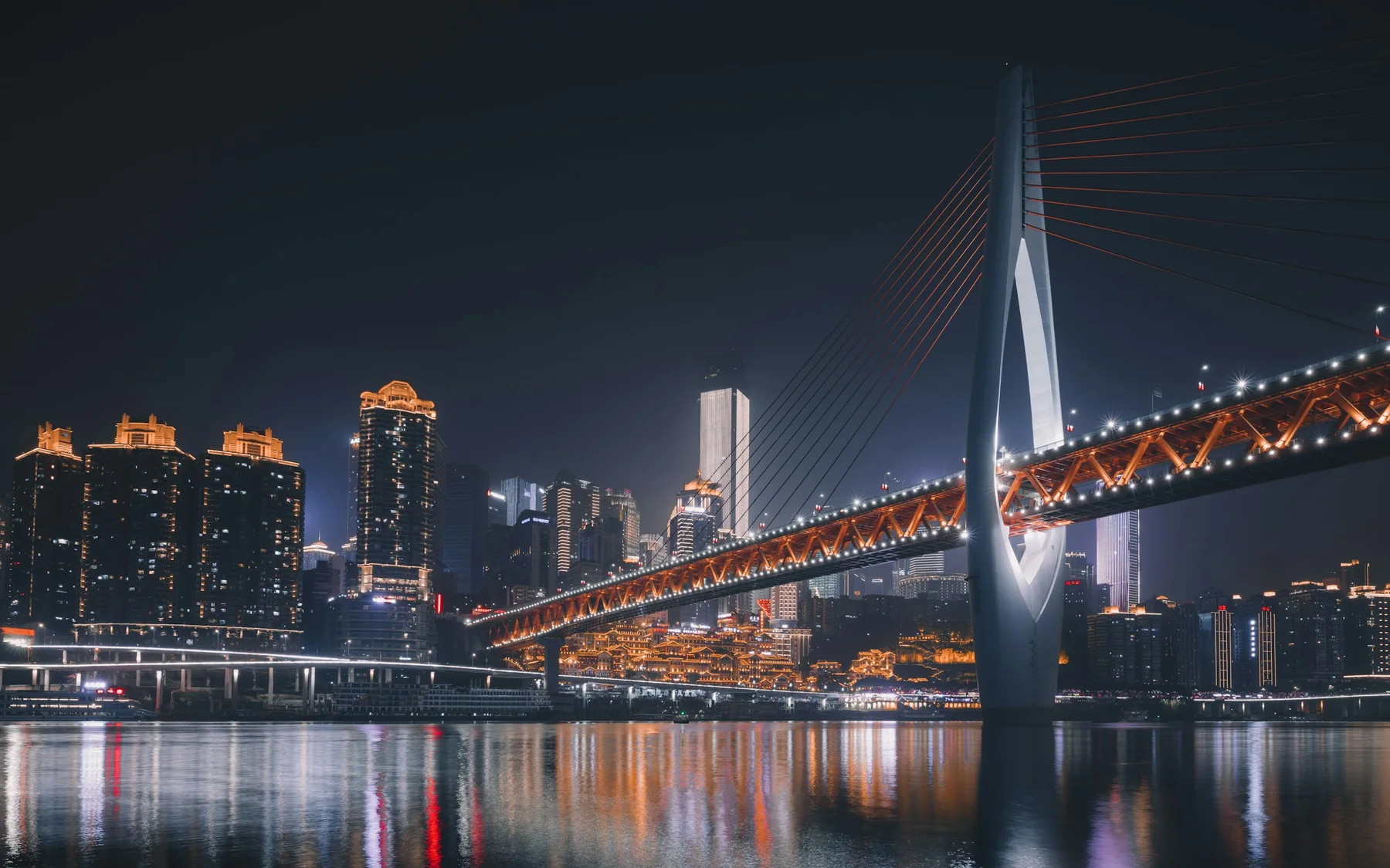 Qiansimen Bridge crossing the Jialing River above Hongya Cave and Chongqing's night skyline