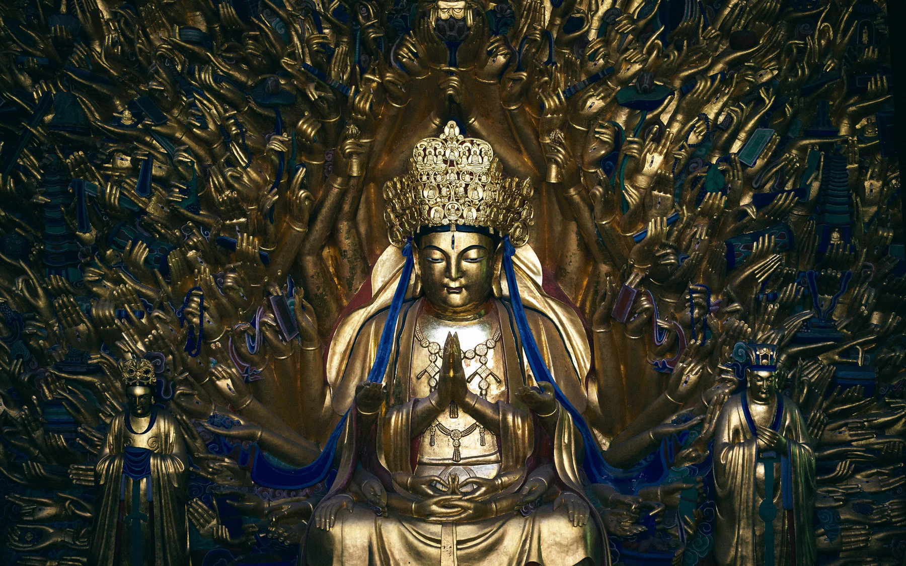 The Thousand-Armed Avalokitesvara at Baodingshan, with its central gilded figure surrounded by a dense field of carved hands.