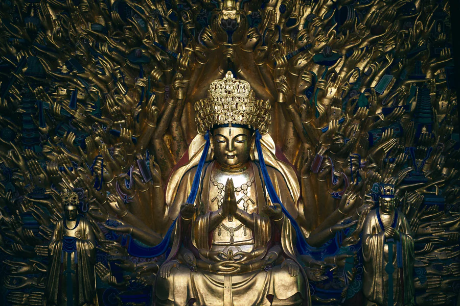 The Thousand-Armed Avalokitesvara at Baodingshan, with its central gilded figure surrounded by a dense field of carved hands.