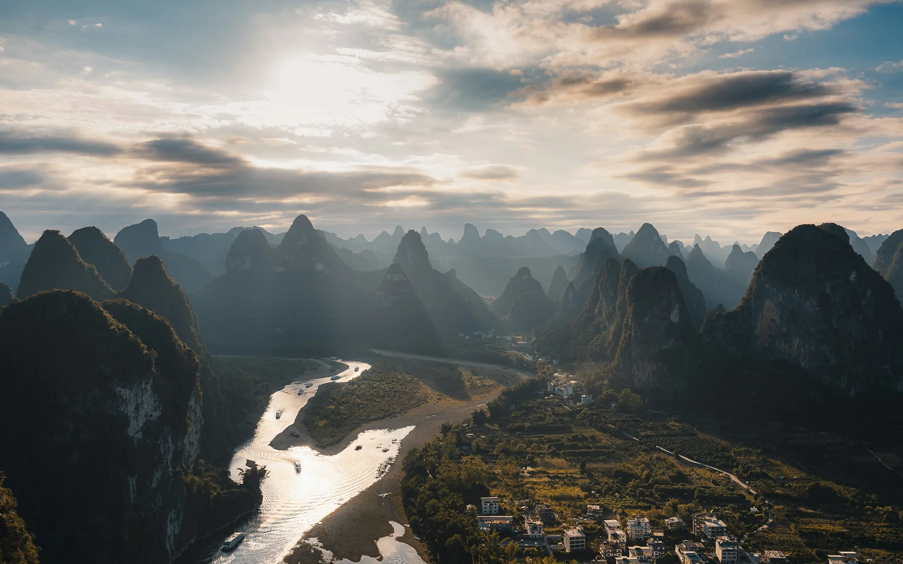 The Li River winding through karst peaks near Guilin in warm morning light