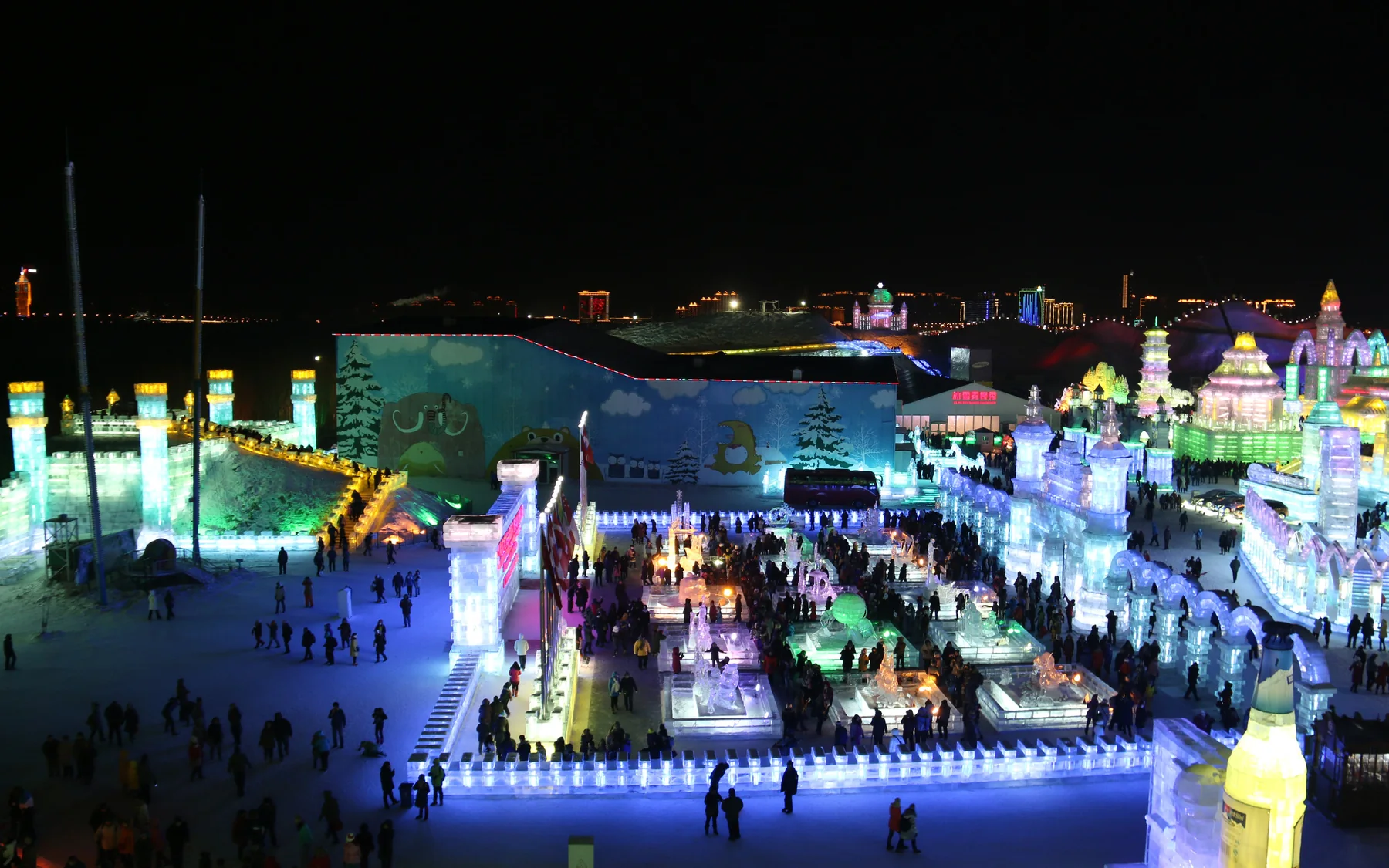 Illuminated ice palaces and towers at Harbin Ice and Snow World after dark