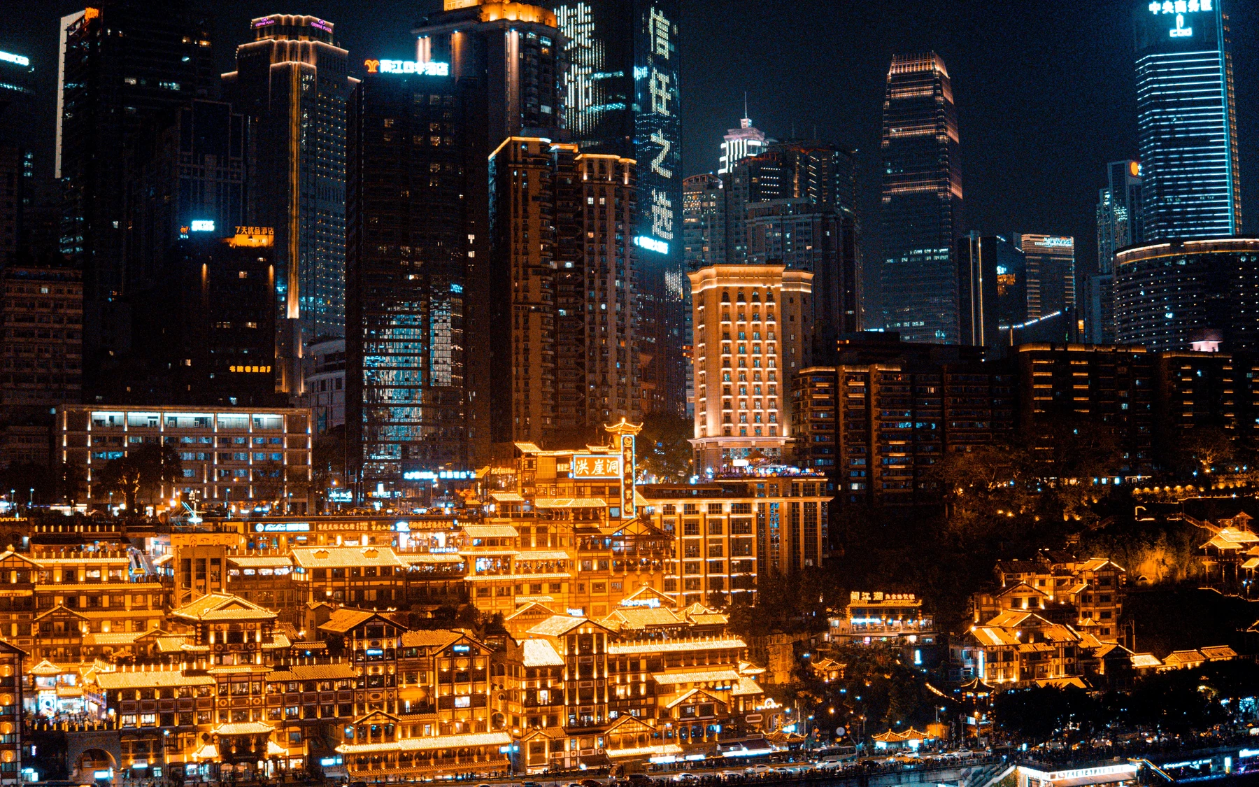 The illuminated full riverfront facade of Hongyadong beneath Chongqing's dense night-time skyline.
