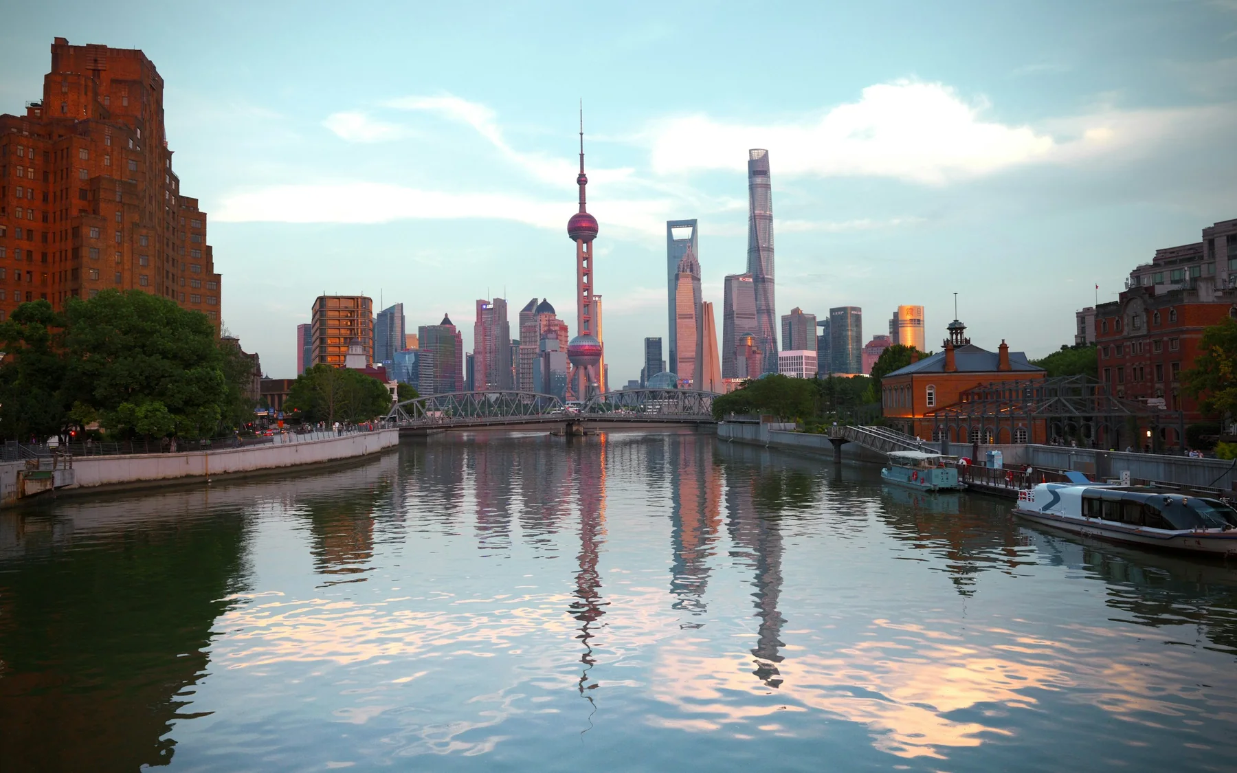 The Lujiazui skyline reflected in water beyond historic waterfront buildings near the Bund in Shanghai