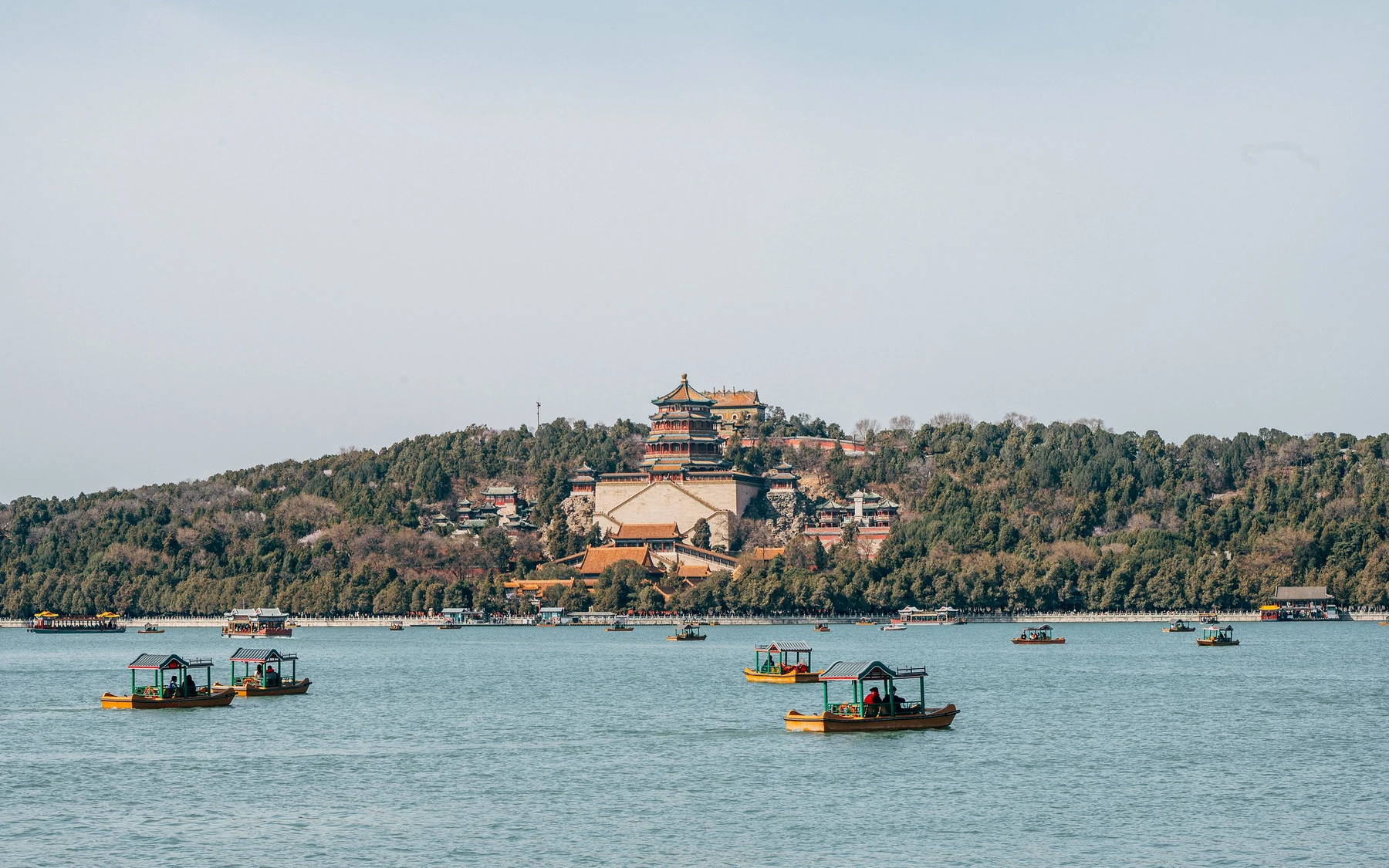 The Tower of Buddhist Incense and Longevity Hill rising beyond boats on Kunming Lake at Beijing's Summer Palace