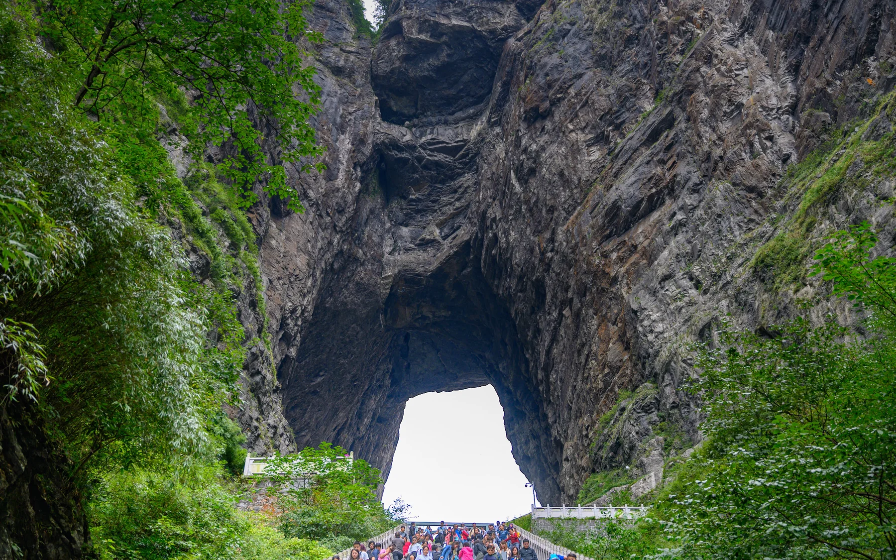 The monumental natural arch of Tianmen Cave framed by its steep Stairway to Heaven