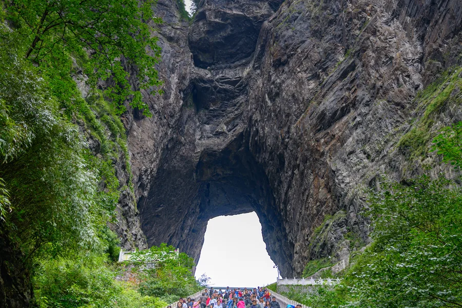 The monumental natural arch of Tianmen Cave framed by its steep Stairway to Heaven