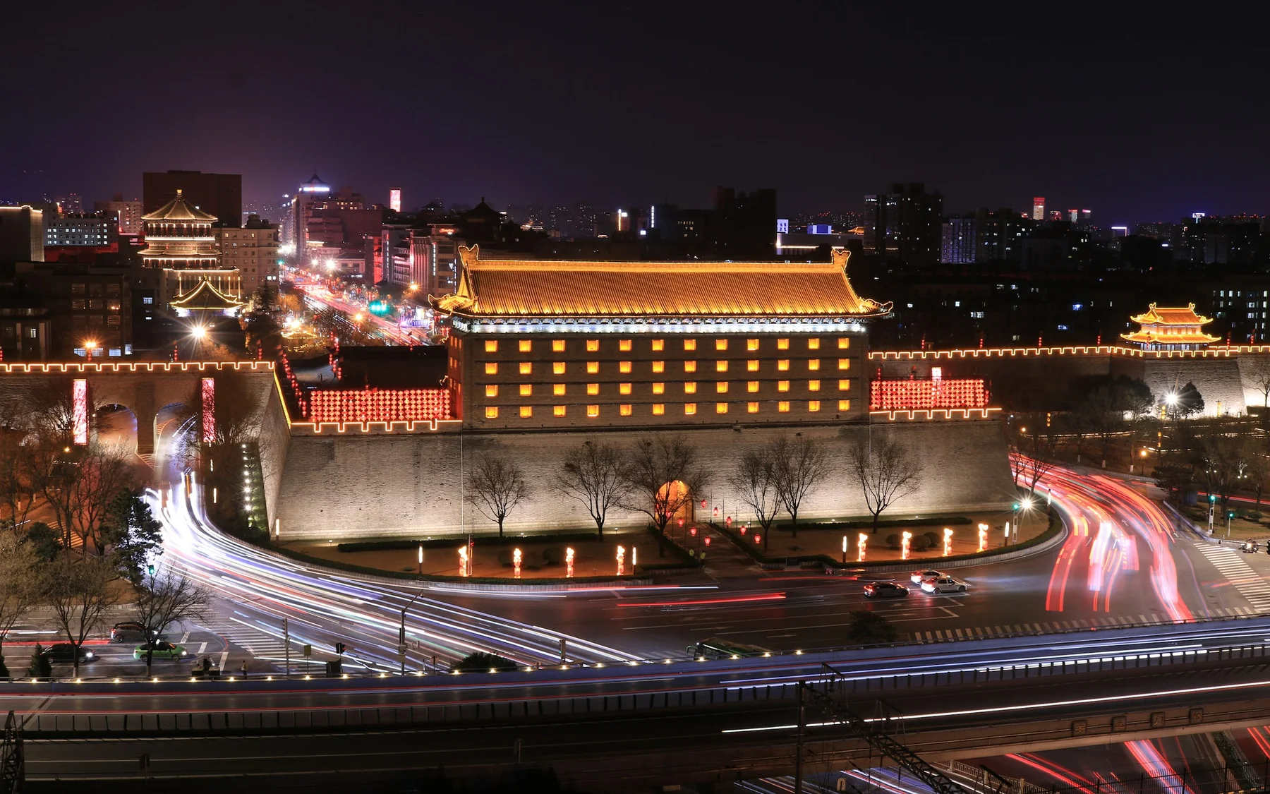 Xi'an City Wall and a gate tower illuminated at night above flowing traffic