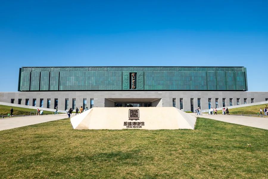 Front elevation of the new Yinxu Museum in Anyang, with its long green facade, central approach and reflecting pools forming a symmetrical composition.